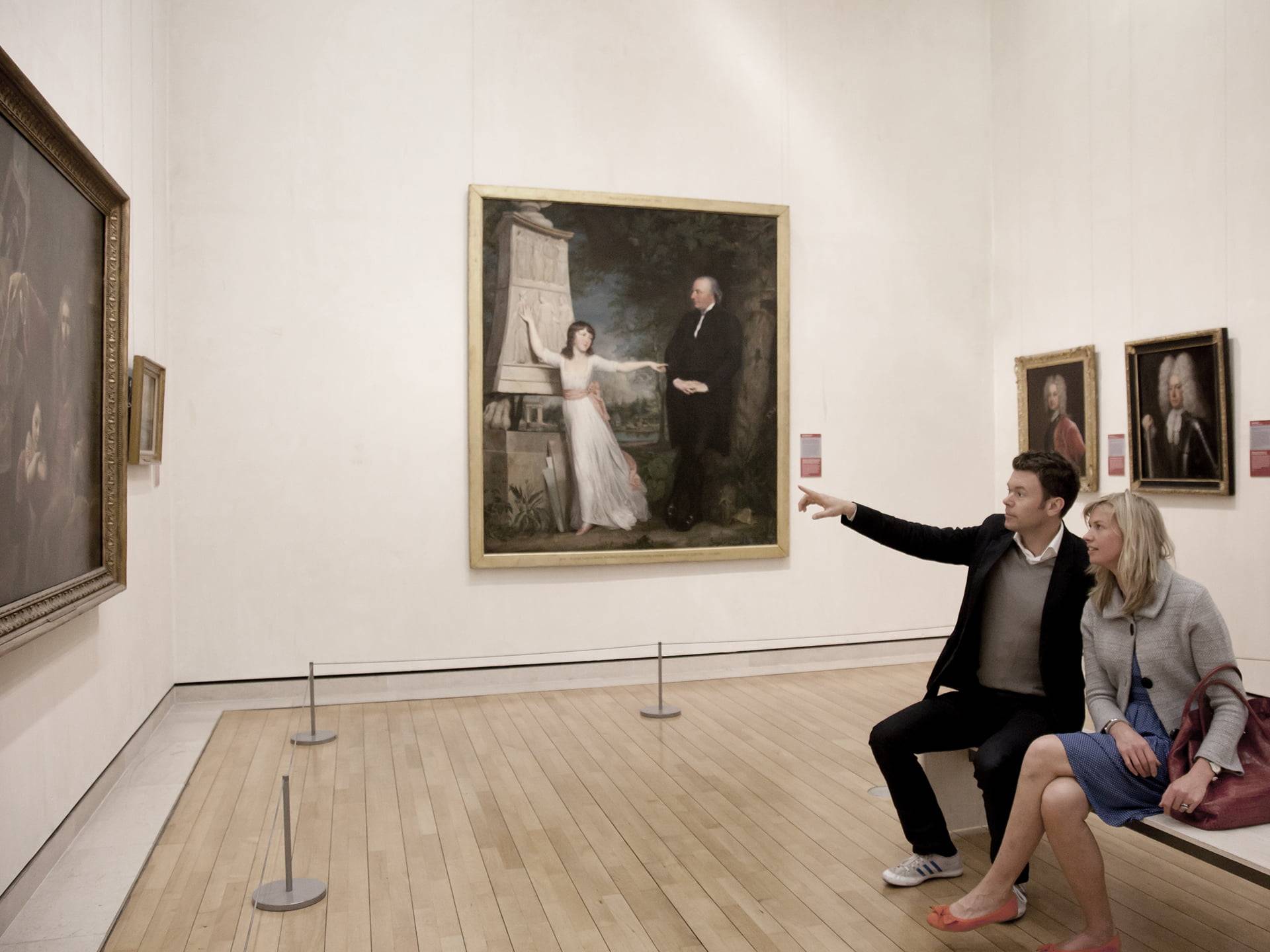 Couple looking at paintings in the National Gallery of Ireland, a well known Dublin art gallery